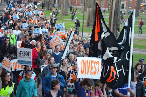 Divest Harvard activists and supporters march through Harvard Yard