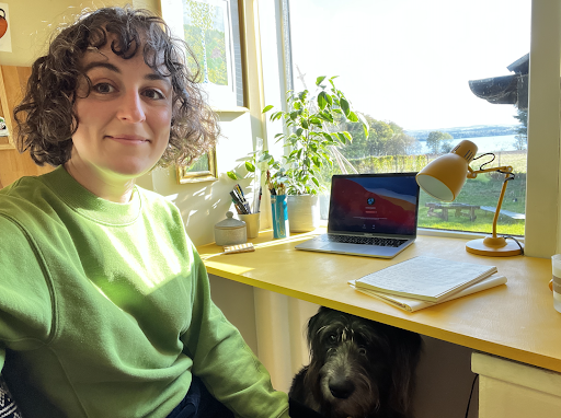 Matilda and her dog, Merlyn, at Matilda's desk