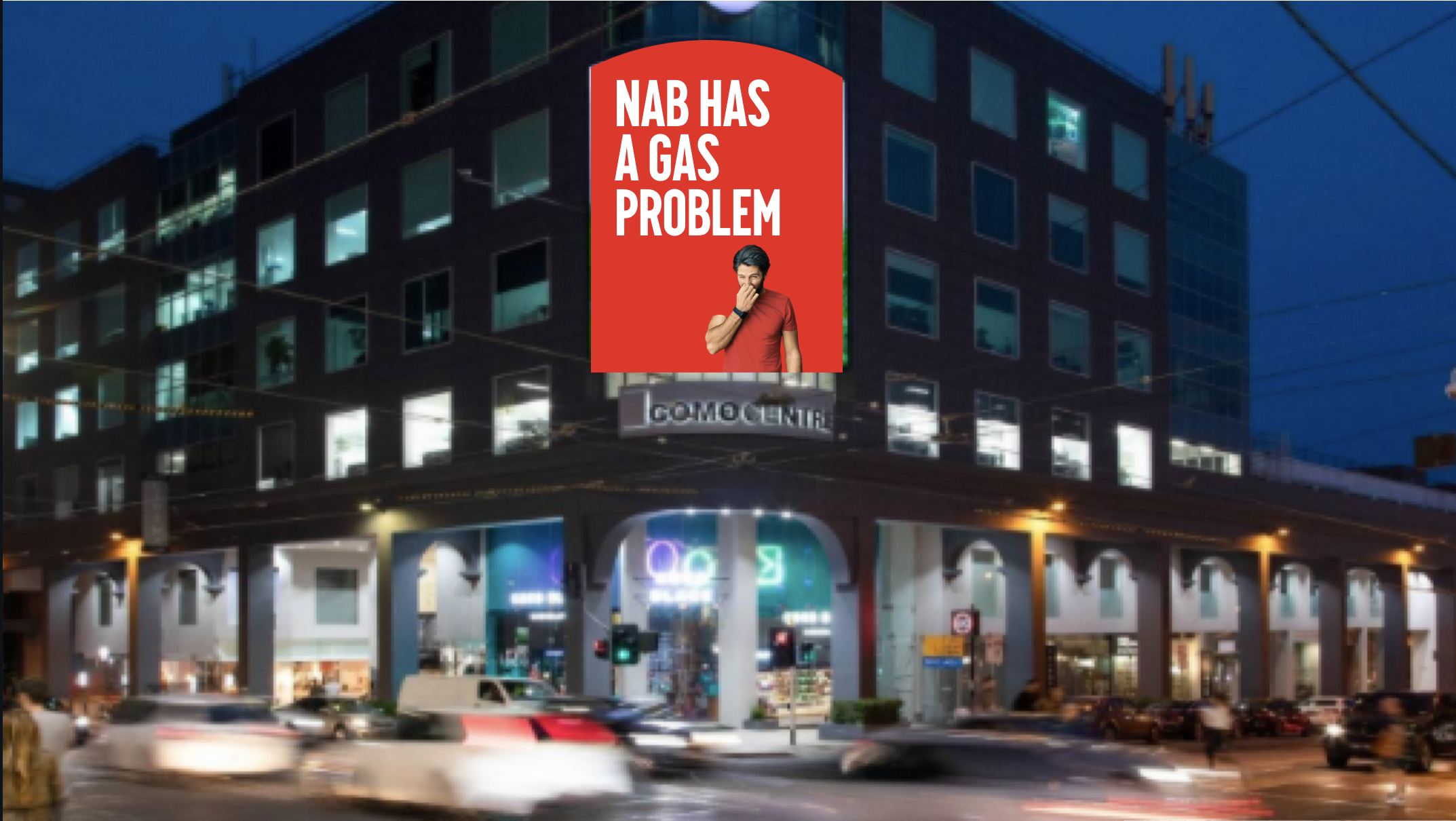 NAB billboard mock up on busy street. The billboard is red and reads 'NAB has a gas problem'