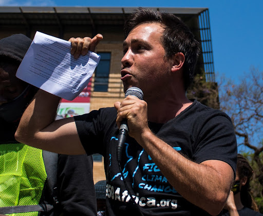 Alex Lenferna at a protest that was part of the #UprootTheDMRE campaign